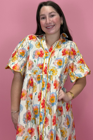 Woman wearing a floral dress against a pink background